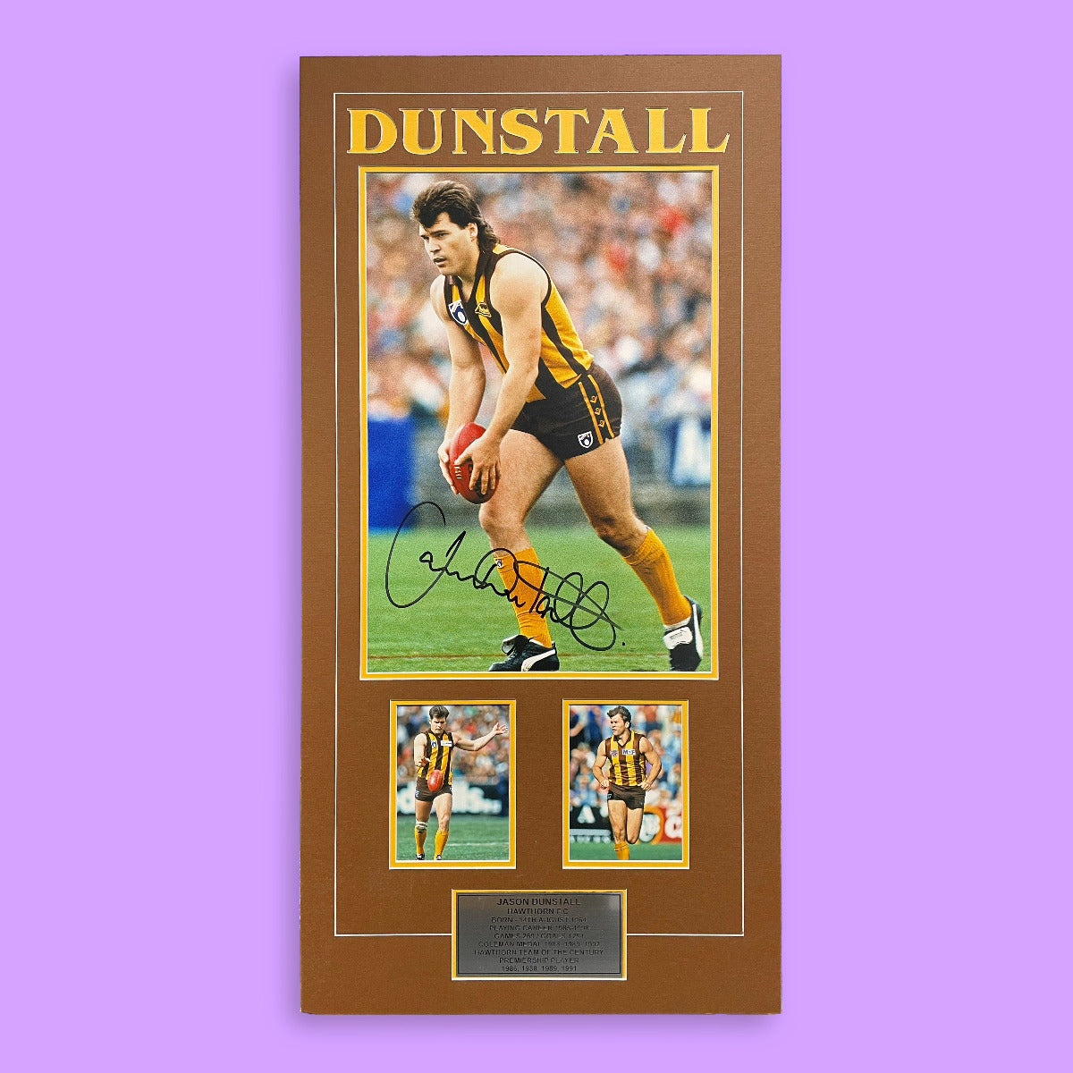 Framed sports memorabilia with a player in a yellow and black uniform on a purple background