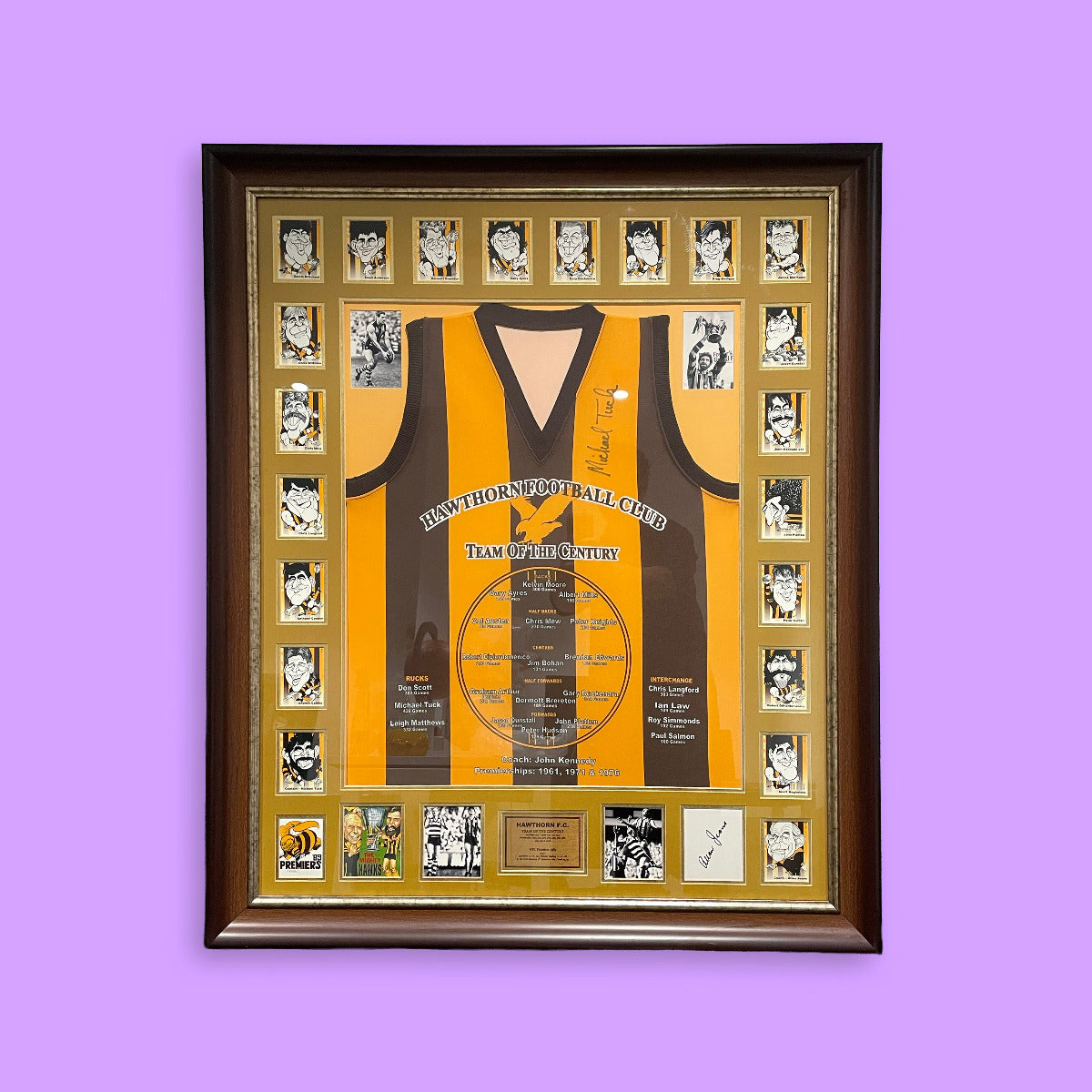 Framed sports jersey with player photos on a purple background