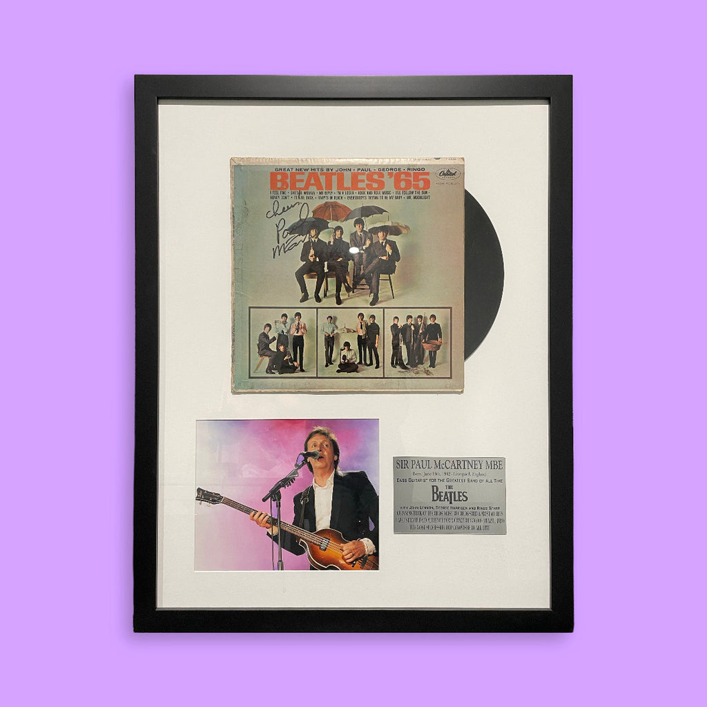 Framed Beatles album cover with a purple background